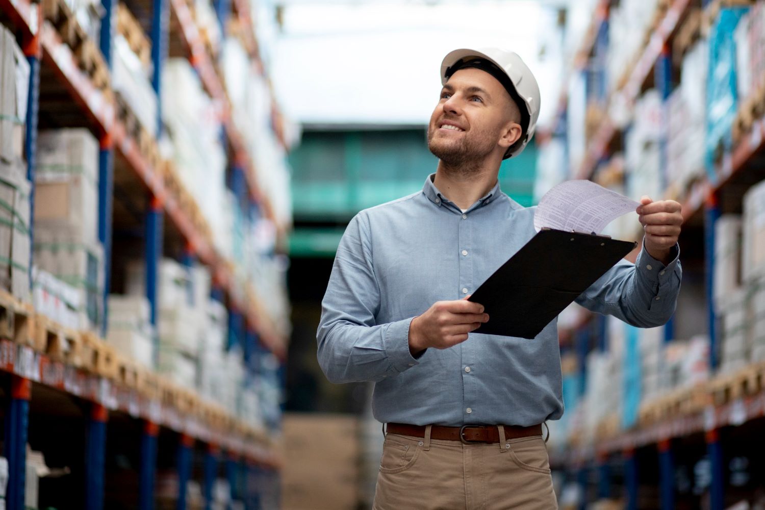 happy warehouse employee using manufacturing software